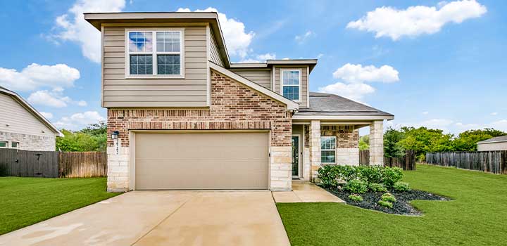 Raptor House with a garage, landscaped lawn, and brick and vinyl siding available through TDY Haven Crash Pad in Schertz, TX