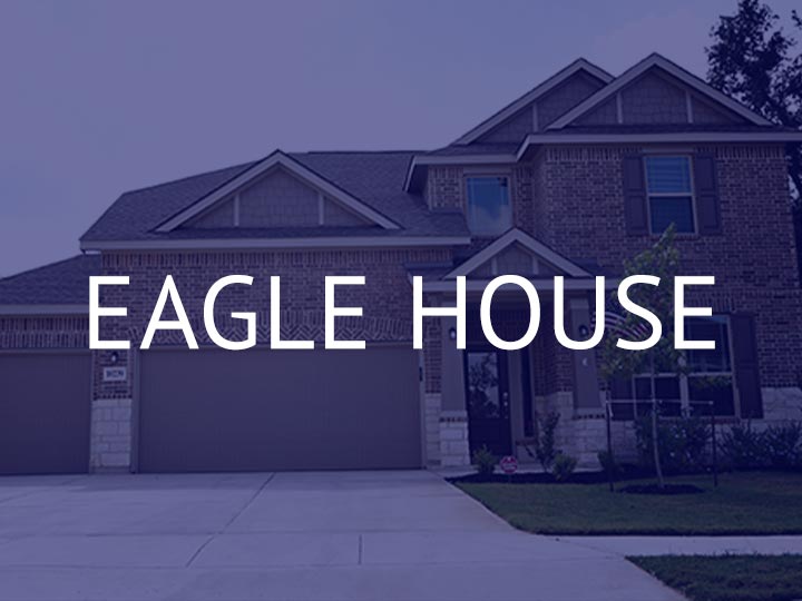 The brick Eagle House with two garages for TDY stays available through TDY Haven Crash Pad in Schertz, TX