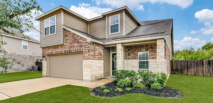 Brick and vinyl siding Raptor House with a garage and landscaped lawn in Schertz, TX available through TDY Haven Crash Pad
